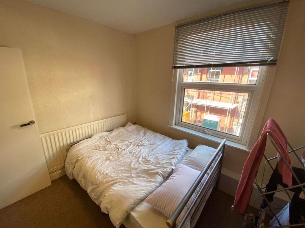 A spacious and well-lit master bedroom featurin...