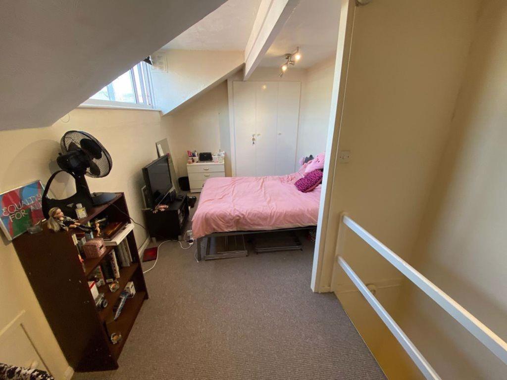 A cozy bedroom with a comfortable double bed, a...