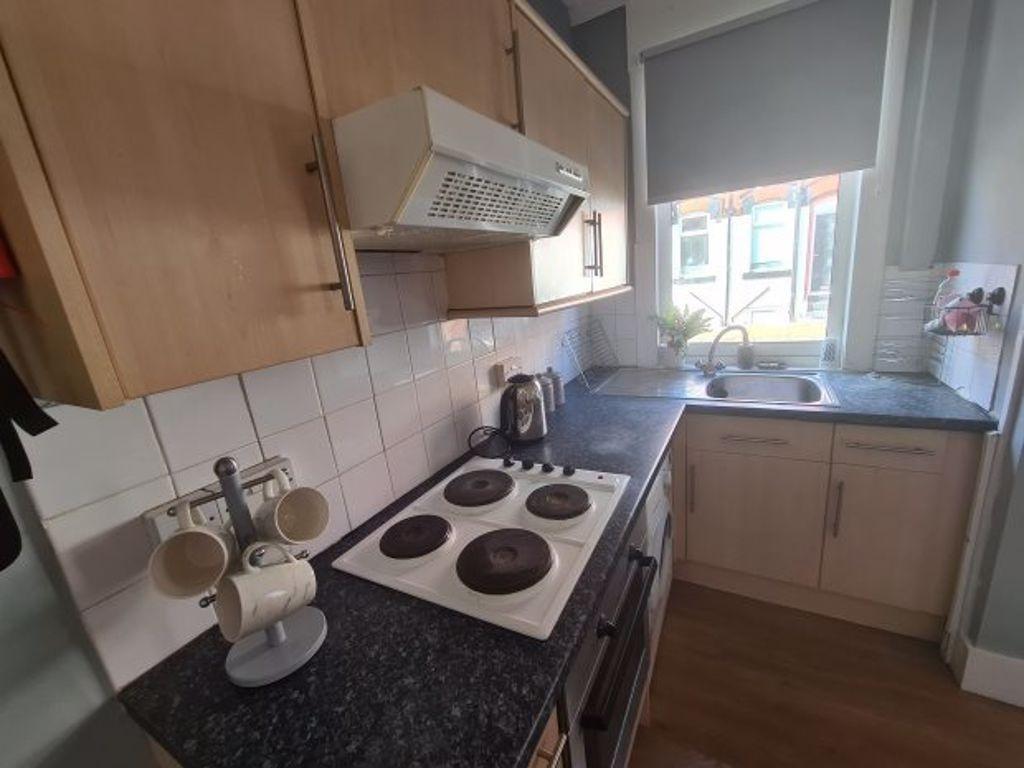 Compact and practical kitchen featuring a clean...