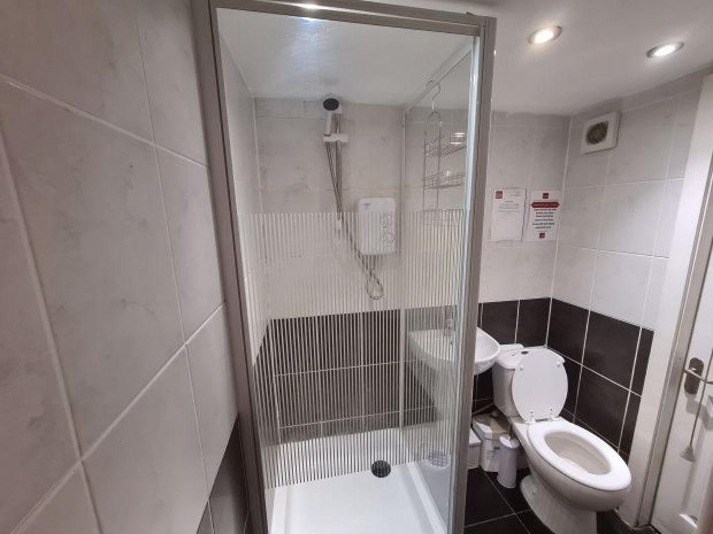 A clean and modern bathroom featuring a shower ...