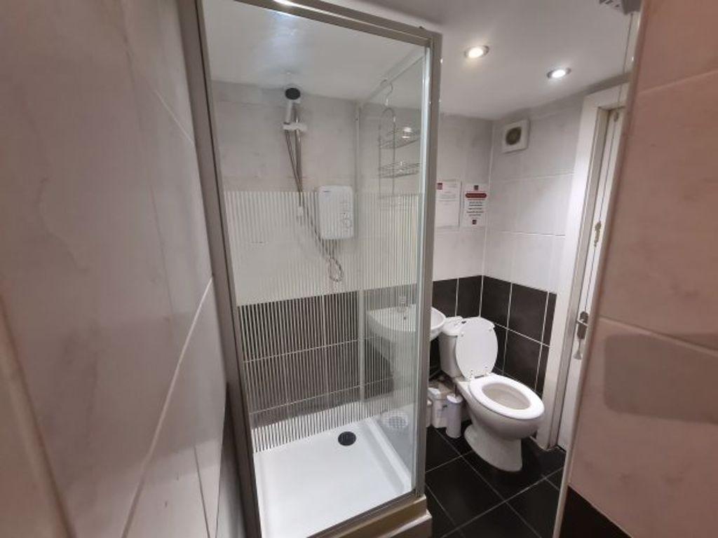 Modern bathroom featuring a spacious walk-in sh...