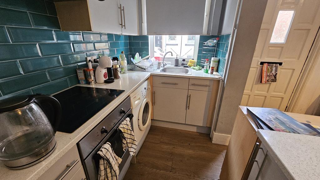 Bright and well-equipped kitchen featuring mode...