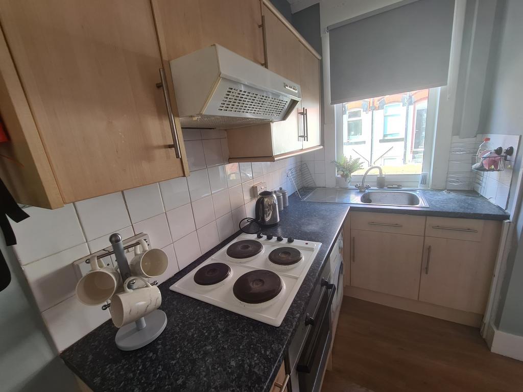 Bright and tidy kitchen space with natural ligh...