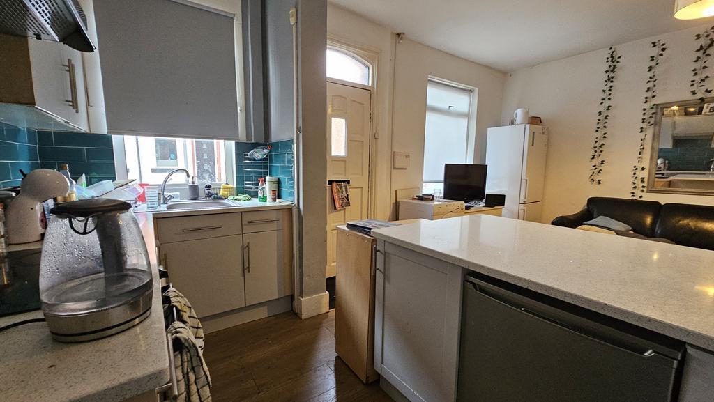 A modern kitchen featuring ample countertop spa...