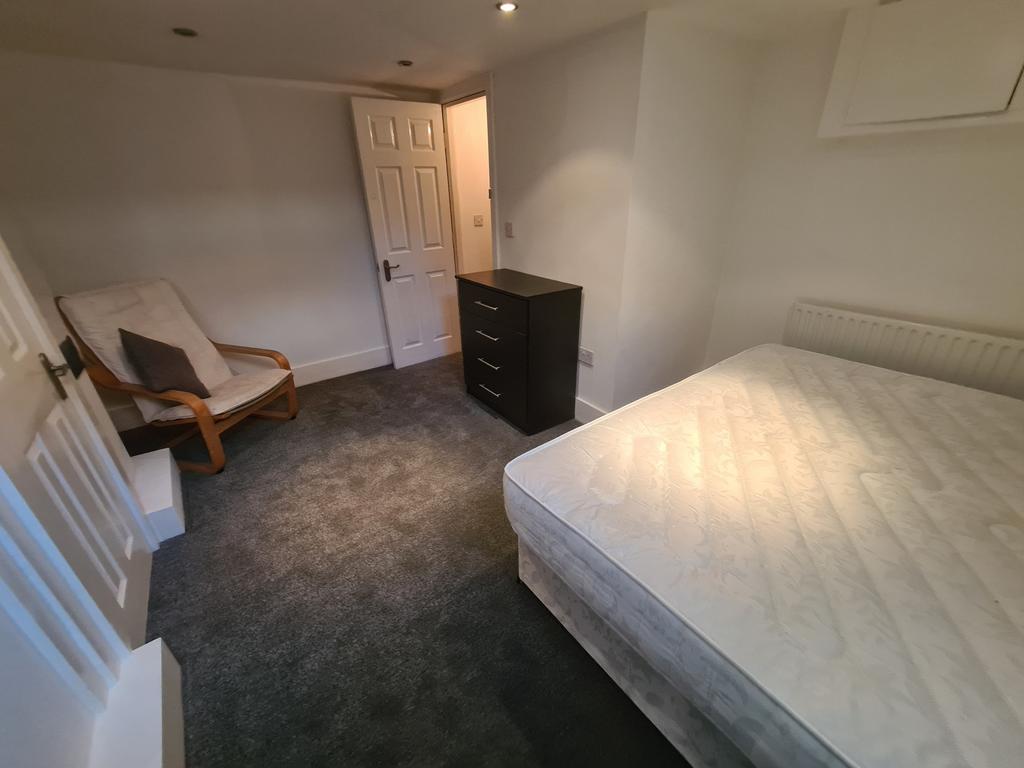 A neat and comfortable double bedroom featuring...