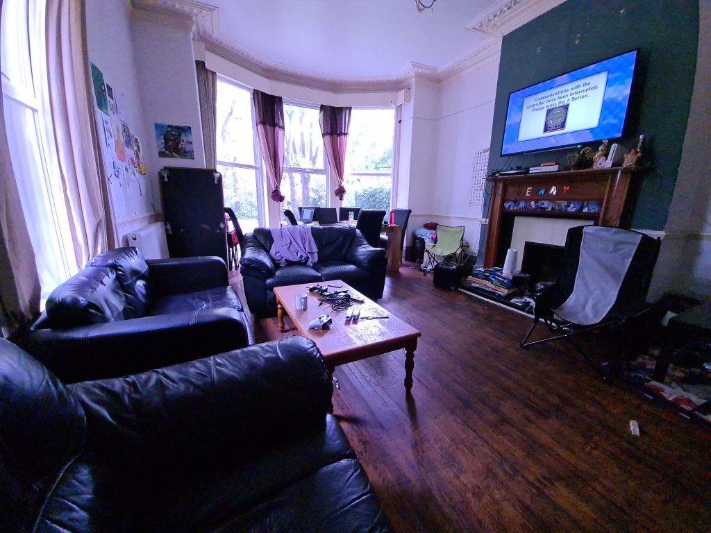 A charming living room featuring a bay window w...