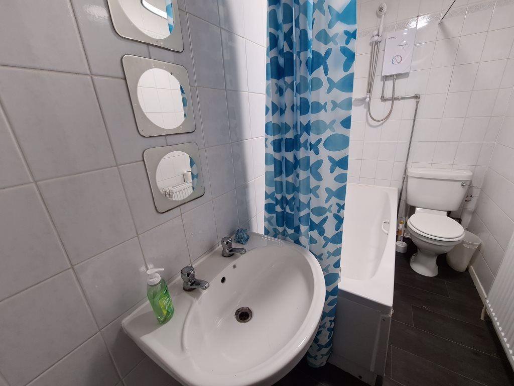 A clean and functional bathroom featuring a whi...
