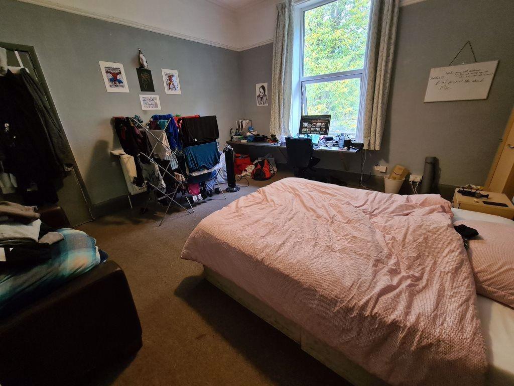 A cozy master bedroom featuring a comfortable d...