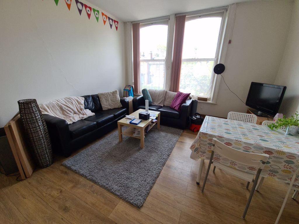 A bright and welcoming living room featuring a ...