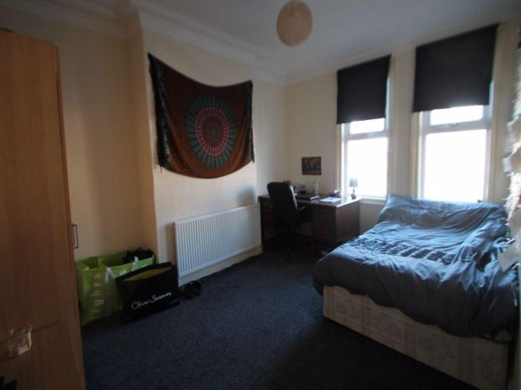 Cozy single bedroom featuring a comfortable bed...