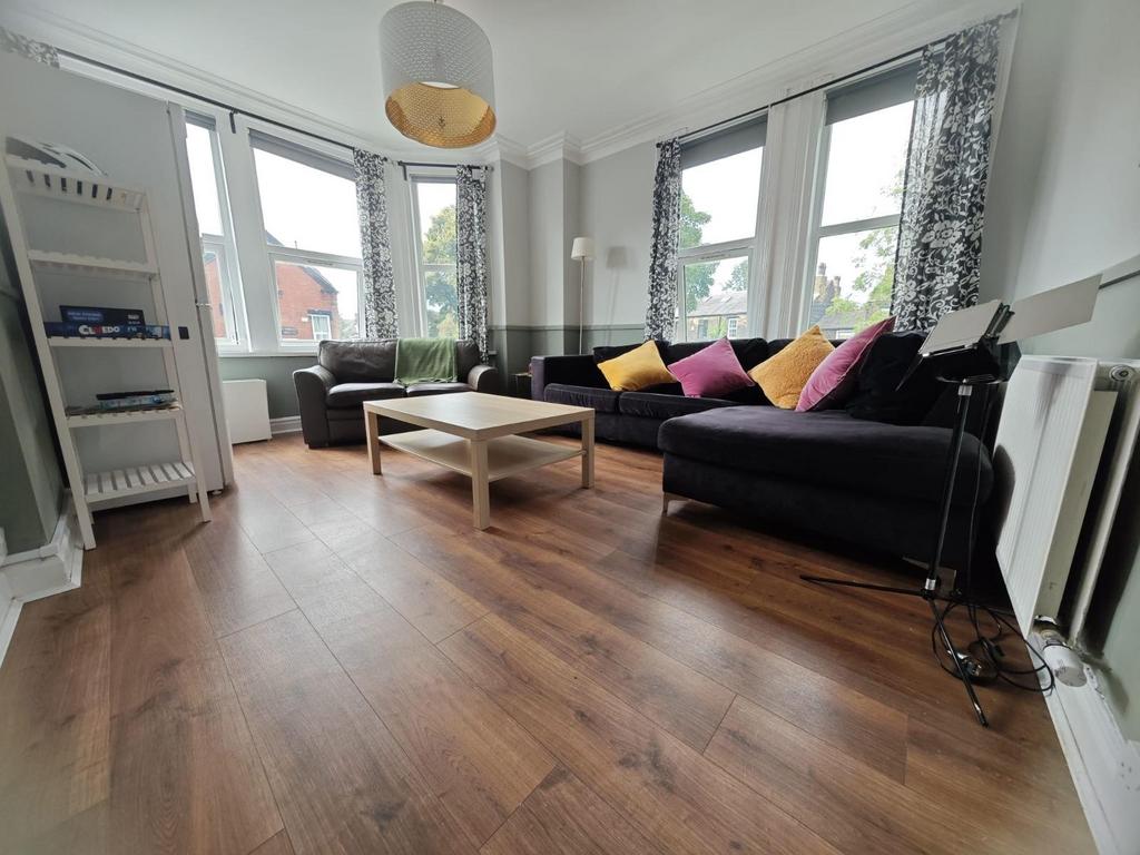 Bright and spacious living room featuring large...
