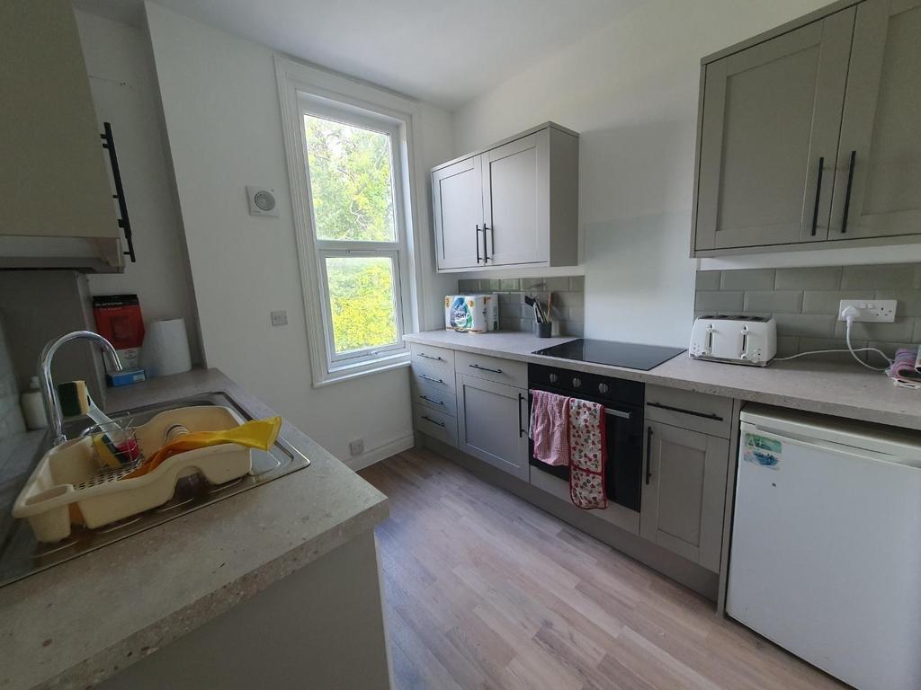 A modern kitchen featuring sleek cabinetry and ...