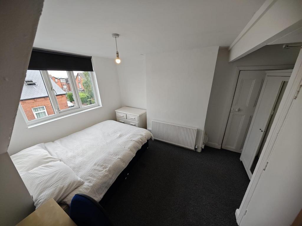 Bright and tidy double bedroom featuring a comf...