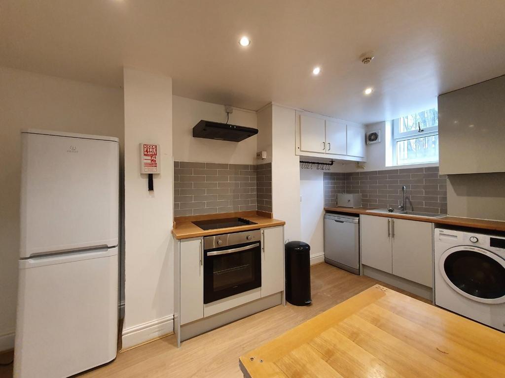 Modern kitchen featuring ample storage, a large...