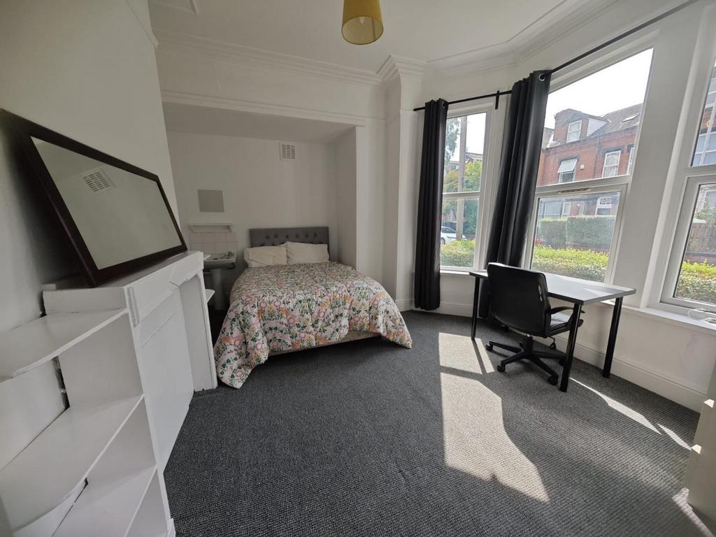 A bright and airy double bedroom featuring a co...