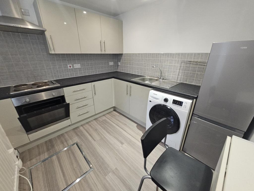 A modern, well-maintained kitchen featuring whi...