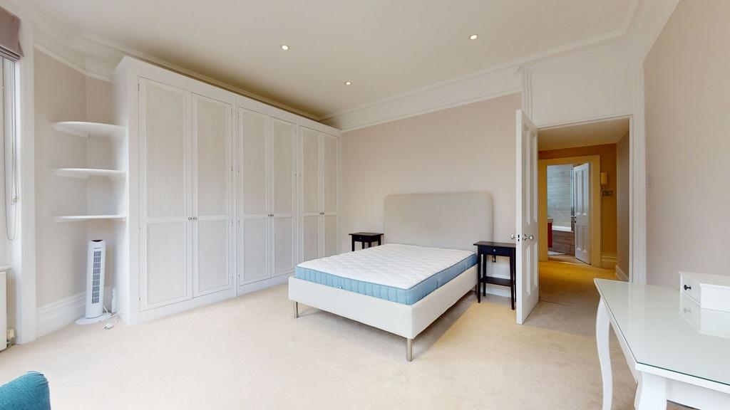 A spacious and bright double bedroom featuring ...