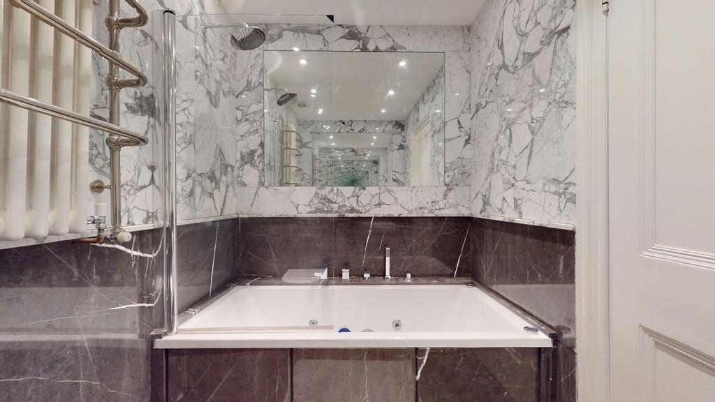 Luxurious bathroom suite featuring elegant marb...