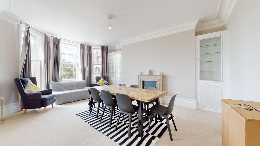 A bright and spacious living room featuring a l...