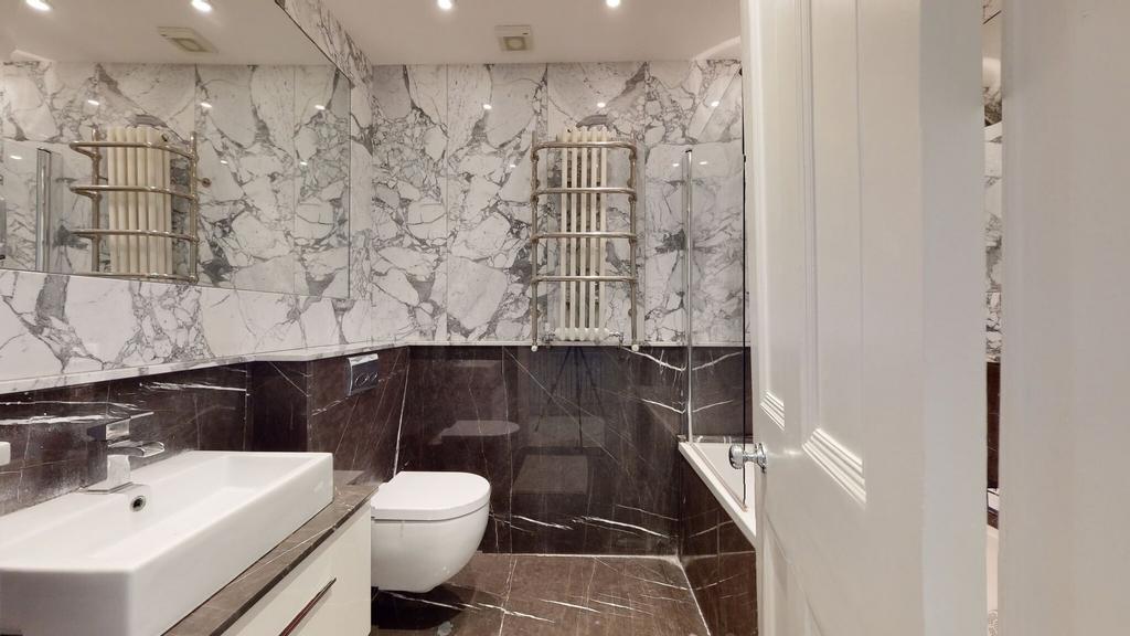 A stylish bathroom suite featuring elegant marb...