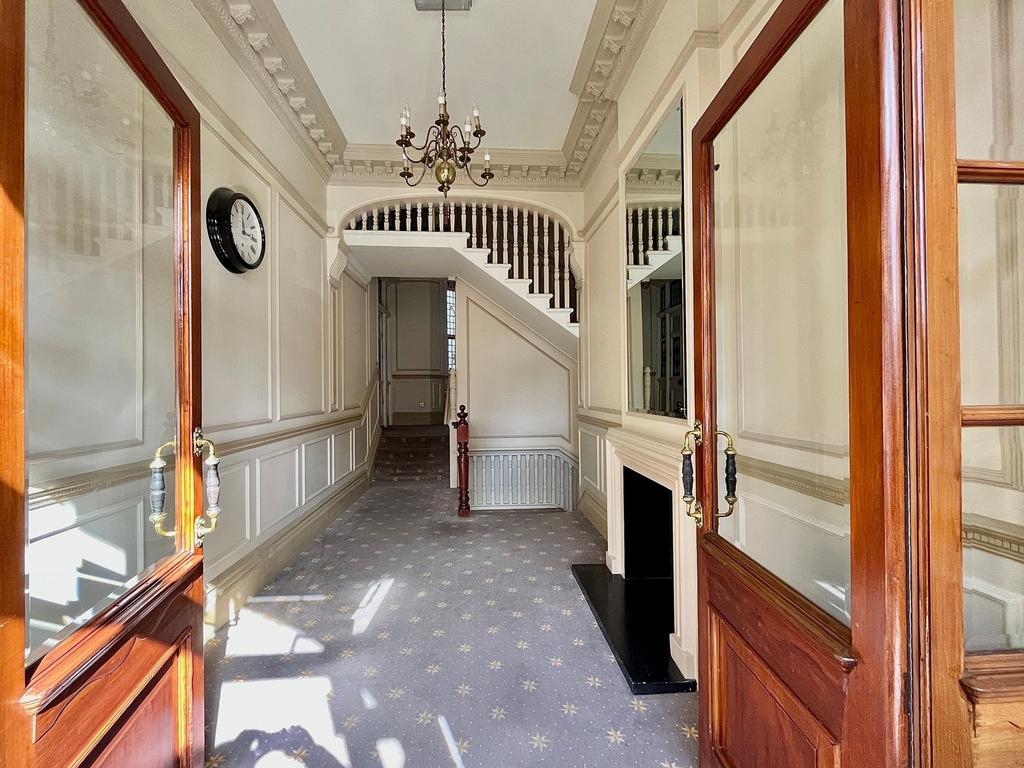 A bright and elegant hallway featuring classic ...