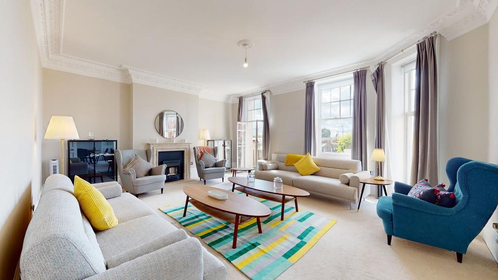 Bright and spacious living room with large wind...