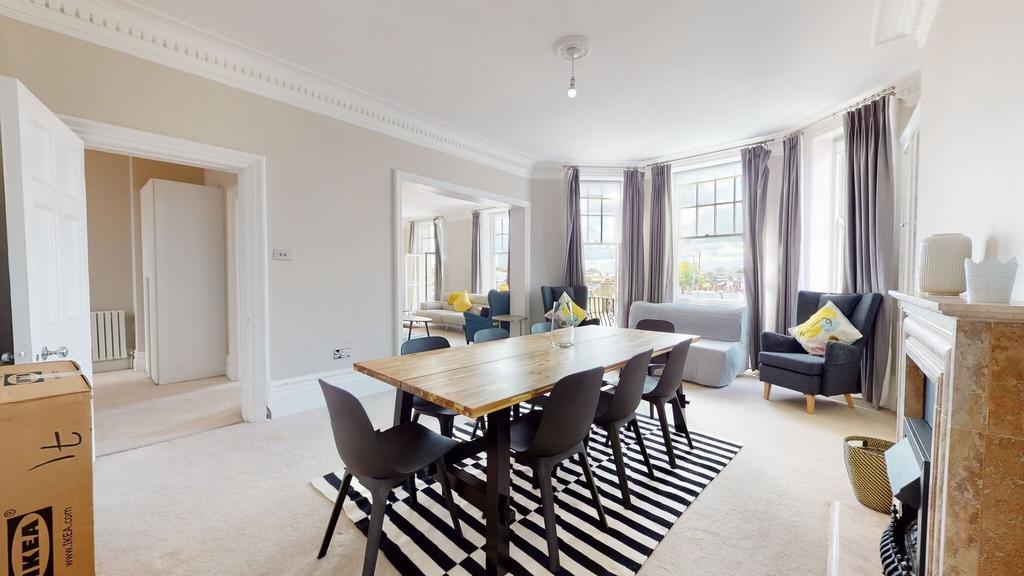 Bright and spacious living room featuring large...