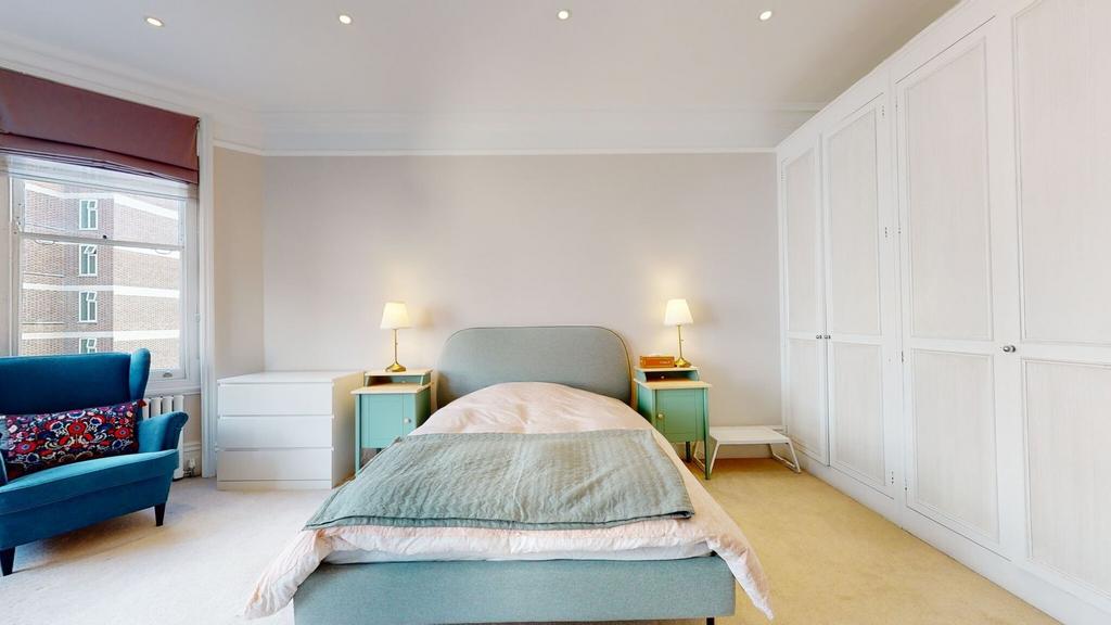 A bright and inviting single bedroom featuring ...