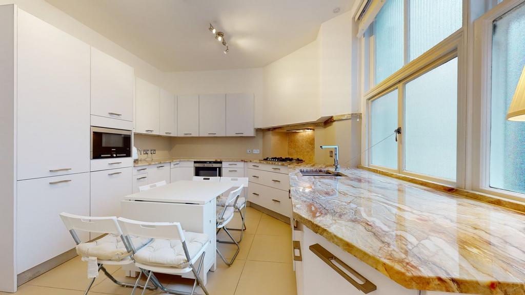 Bright and modern kitchen featuring sleek white...