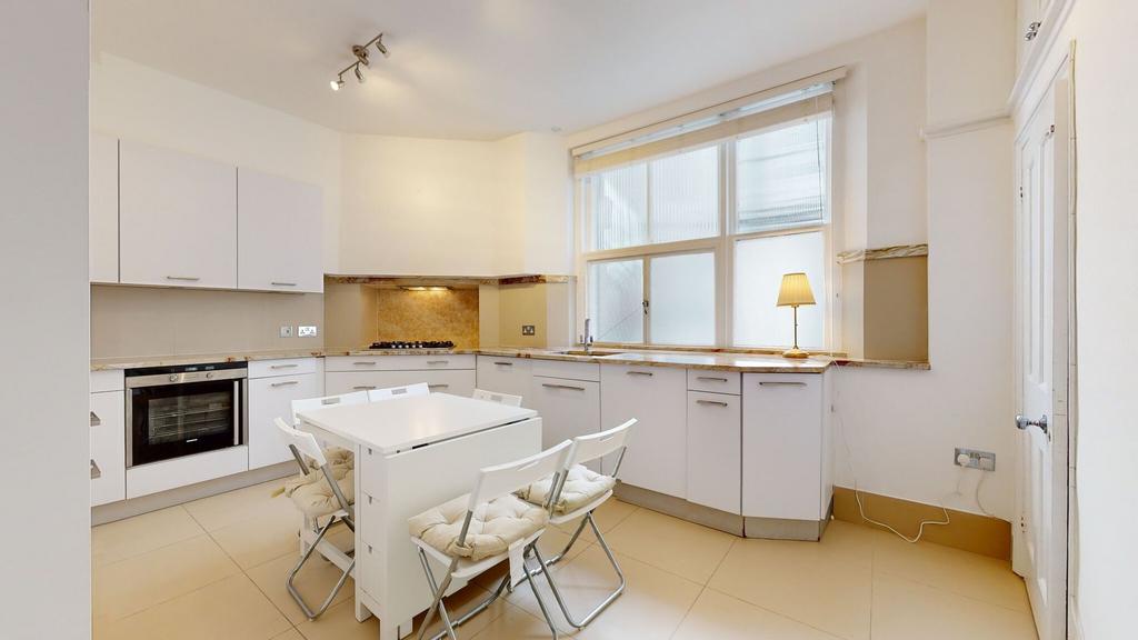 A bright and modern kitchen featuring sleek whi...