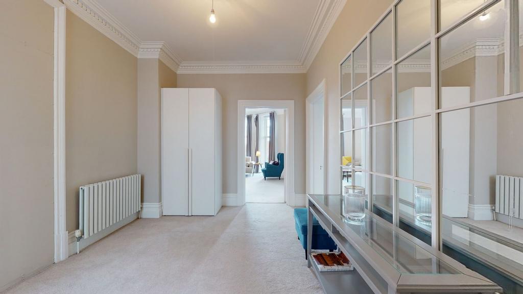 A bright and elegant hallway featuring neutral ...