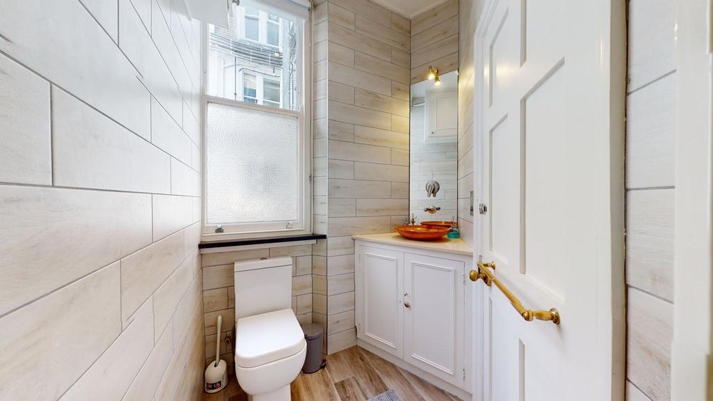 Bright and neat bathroom featuring modern fitti...