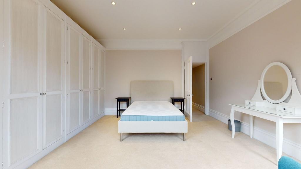 Bright and spacious master bedroom featuring a ...