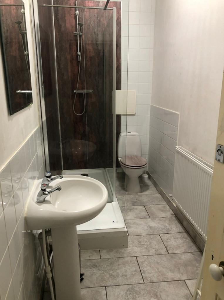 A small and functional bathroom with a shower, ...
