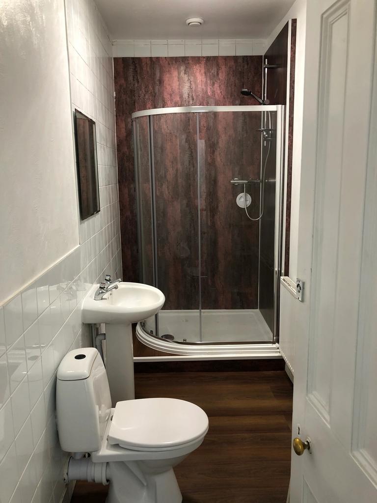 A clean and modern bathroom featuring a shower ...