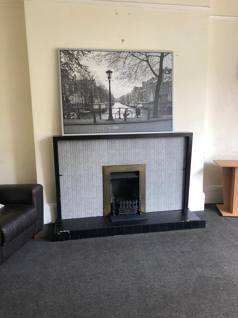 A cozy living room featuring a fireplace and a ...