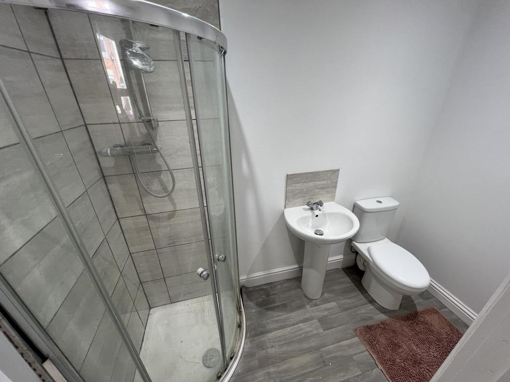 Bright and clean bathroom featuring a modern sh...