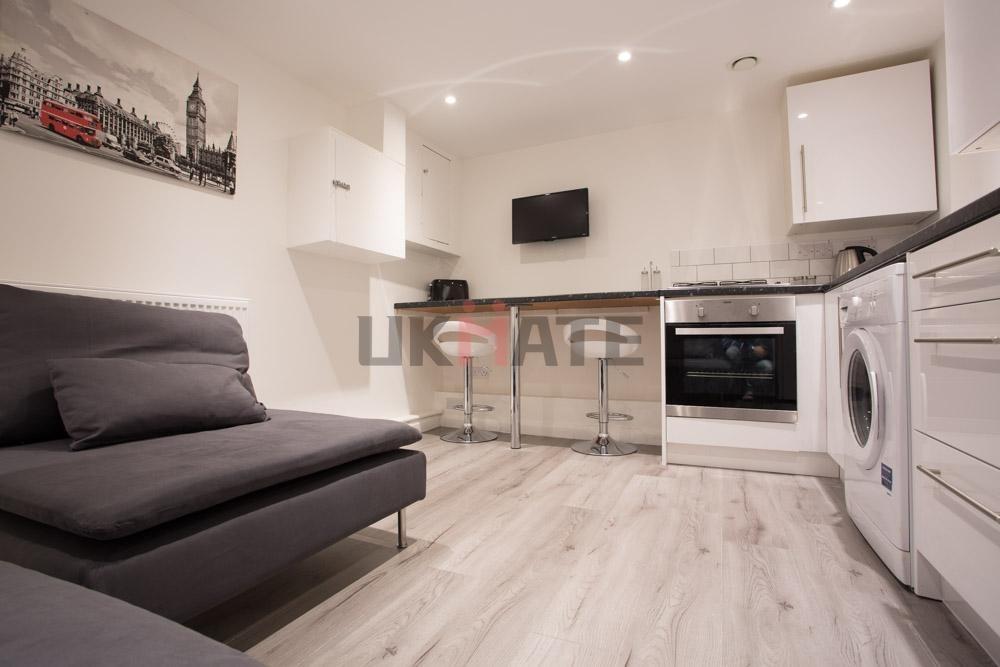 A modern and tidy living area featuring a comfo...