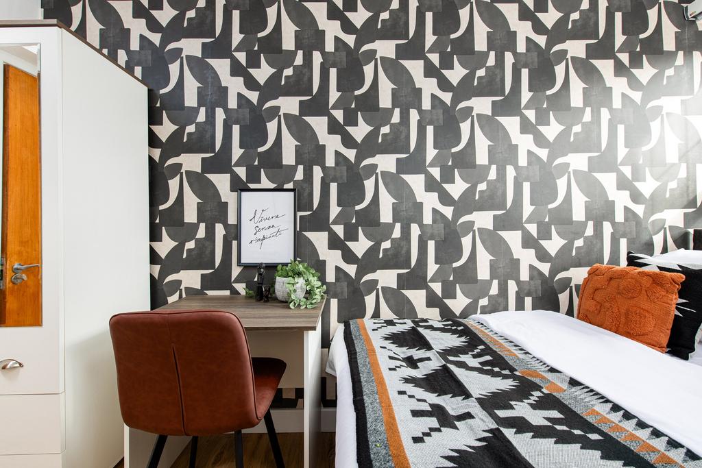 A stylish and contemporary bedroom featuring a ...