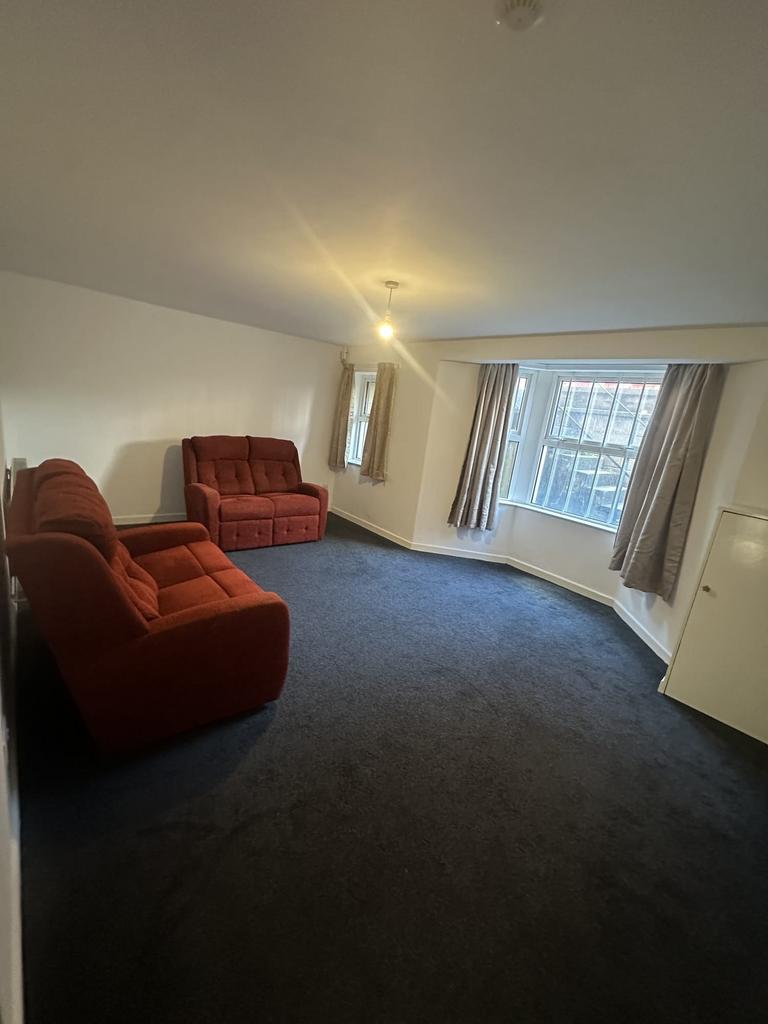 Bright and inviting living room with large bay ...