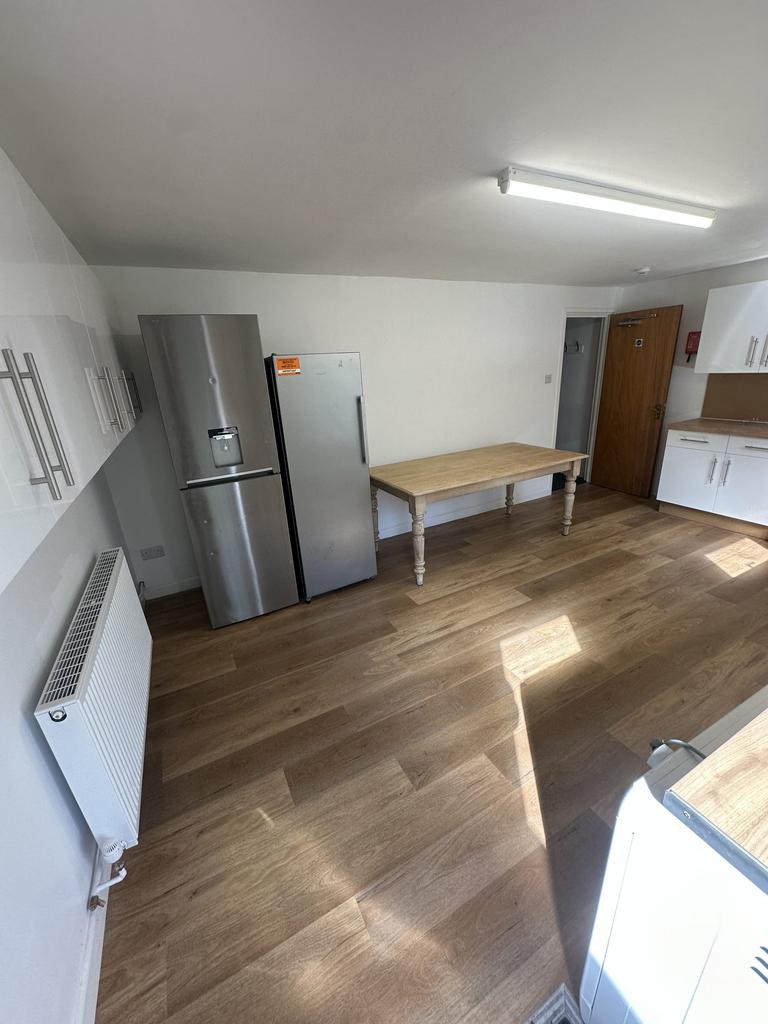 A modern, well-maintained kitchen with wooden f...