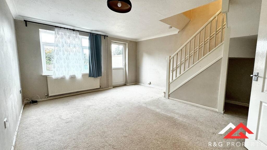 Bright and spacious living room featuring large...
