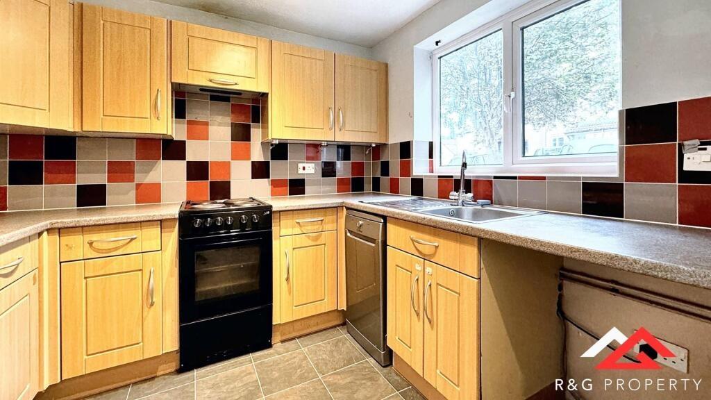 Bright and well-maintained kitchen featuring am...