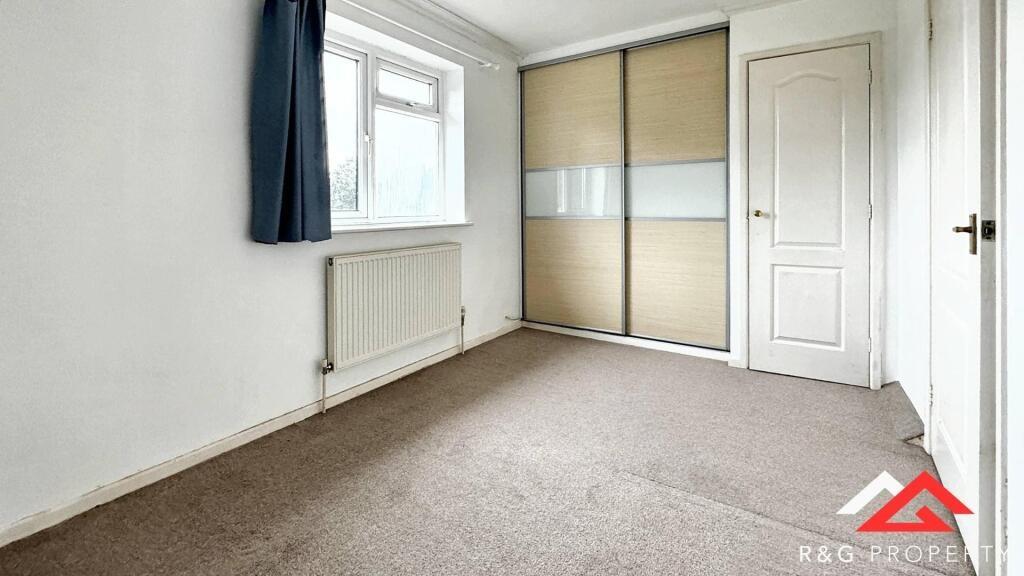 A bright and tidy double bedroom featuring a la...