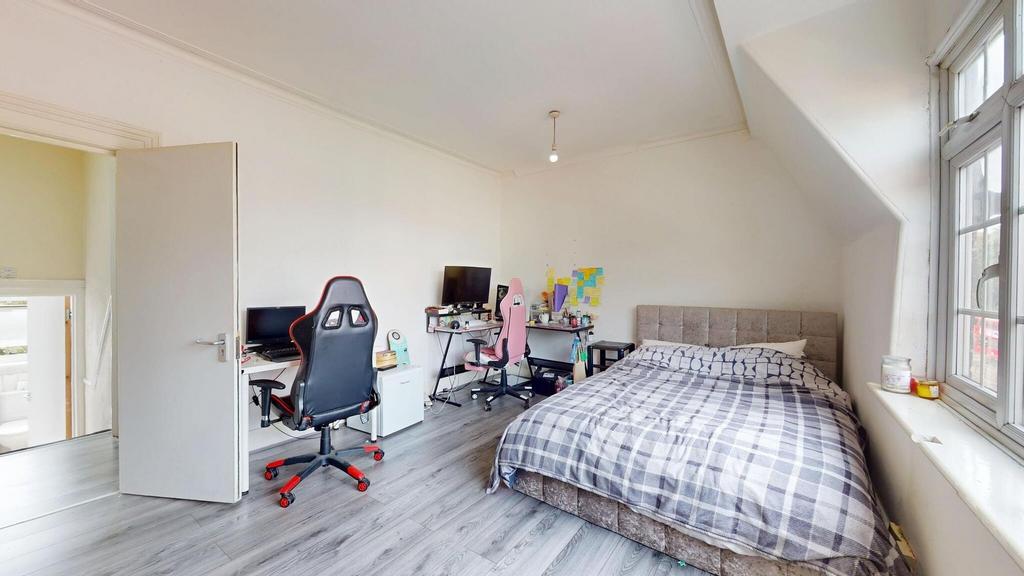 Bright and cozy bedroom with a large bed, ample...