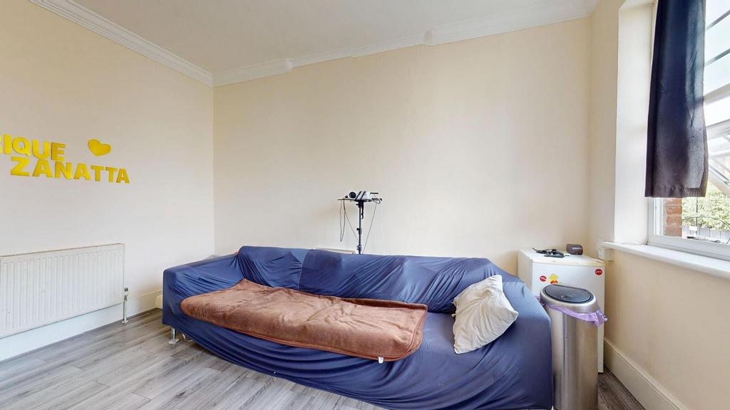 A cozy living space featuring a sofa, window wi...