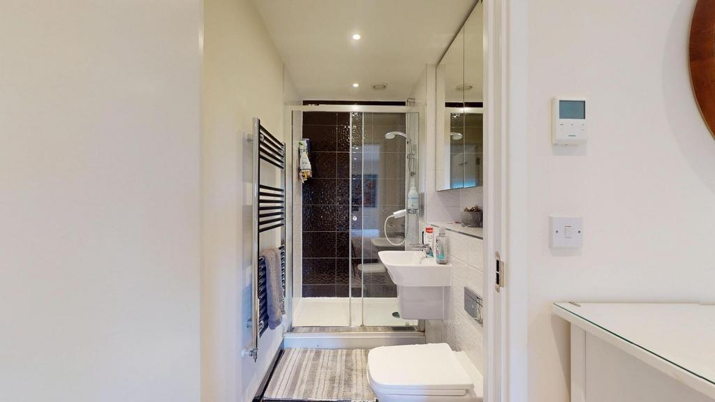Bright and modern bathroom featuring a walk-in ...