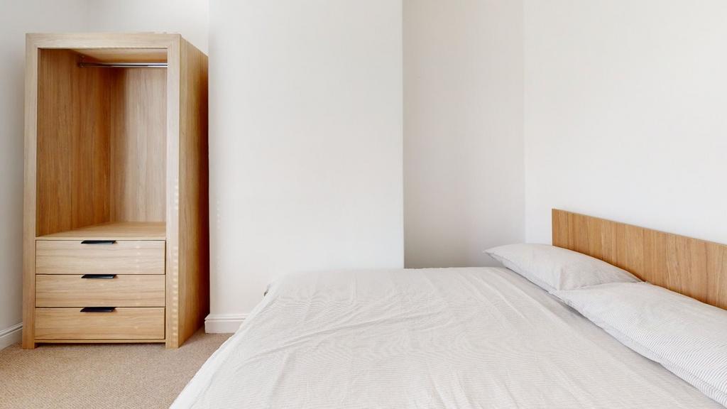 A neatly presented bedroom showcasing a comfort...