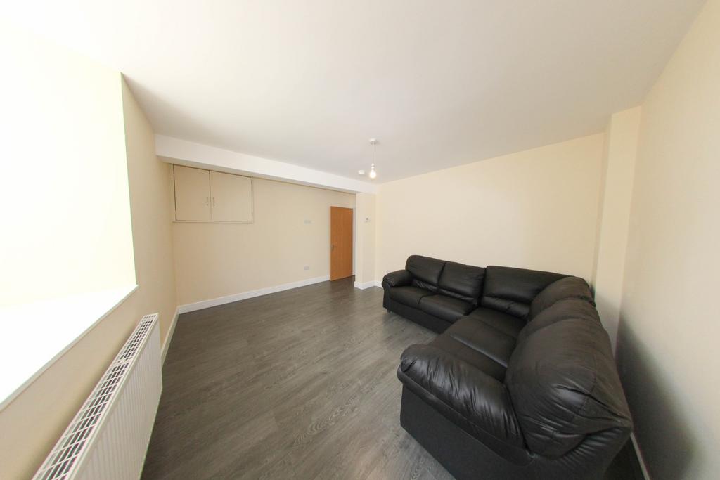 A spacious and tidy living room with a contempo...