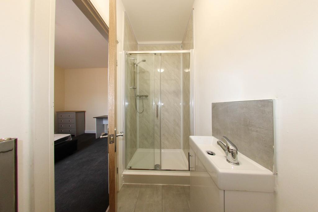 Modern and bright bathroom with a large shower ...